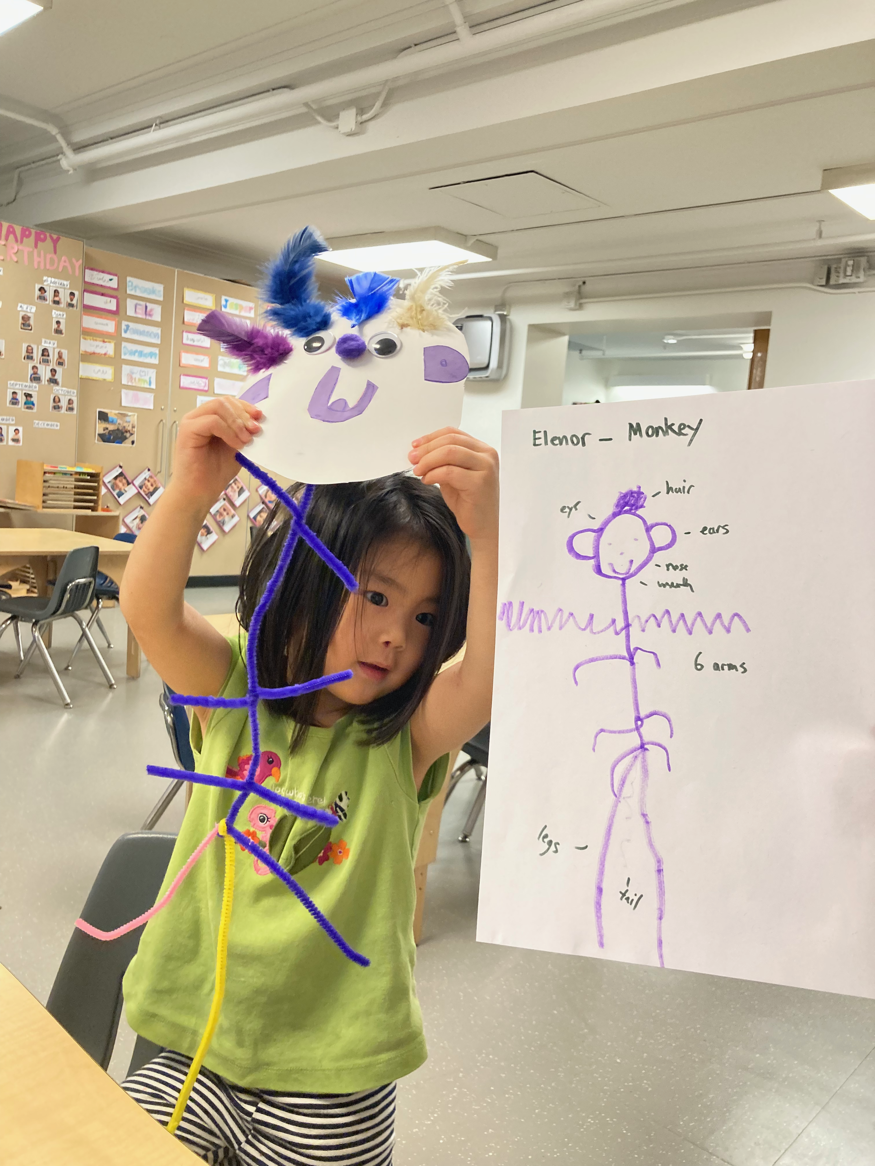 JK student Eleanor holding her monkey sketch and finished puppet