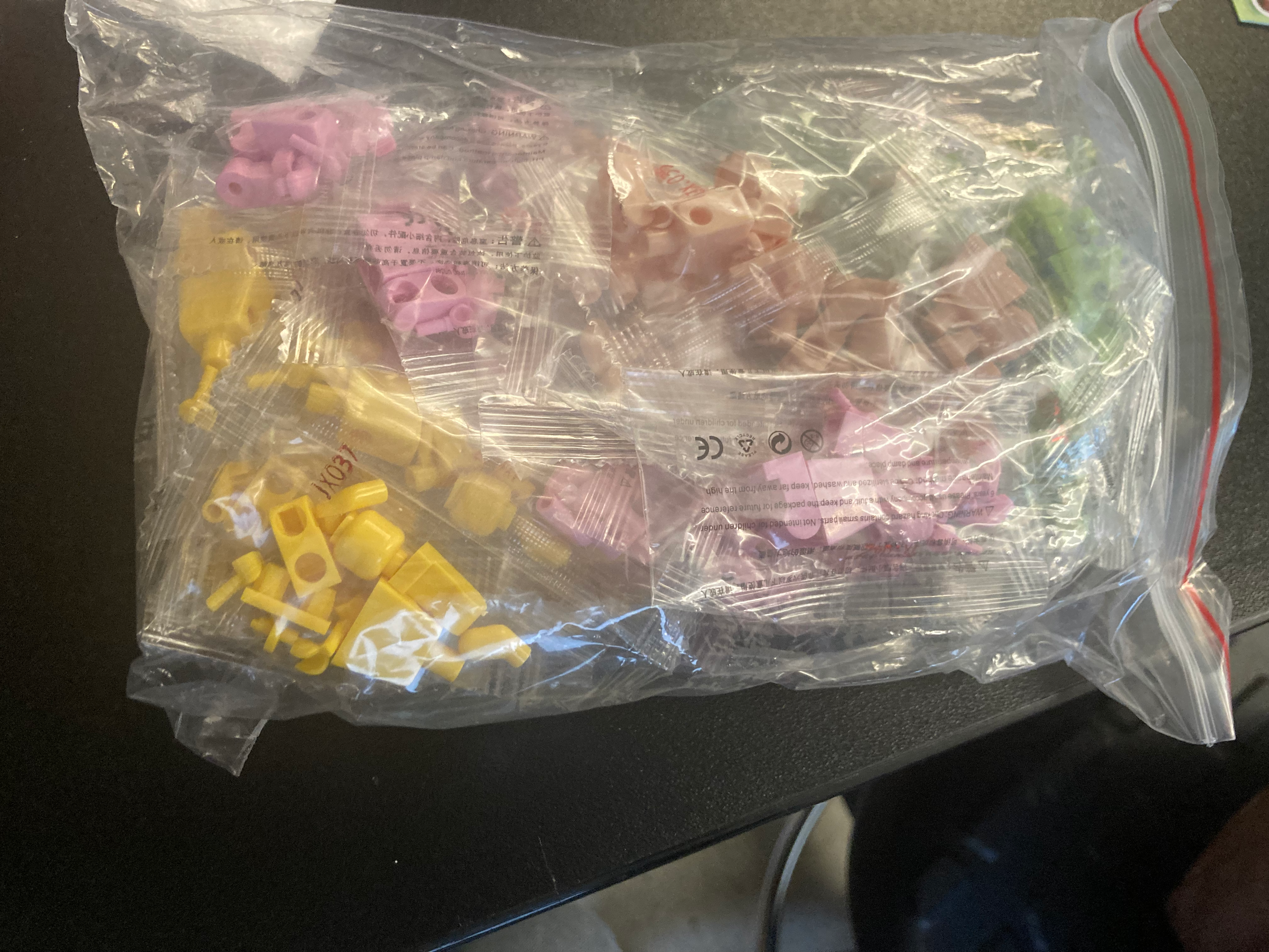 sorted LEGO minifigure parts in bags